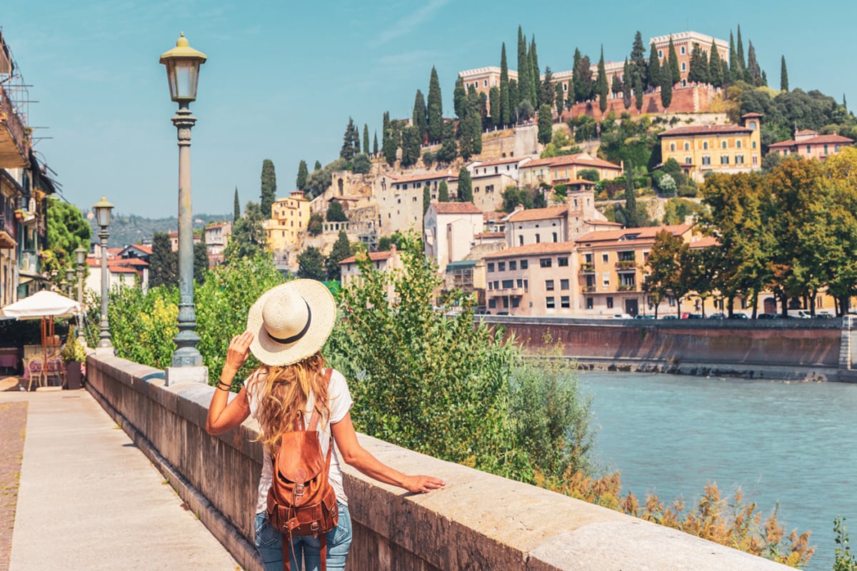 Woman looking at Castel San Pietro in Verona on a beautiful summer day